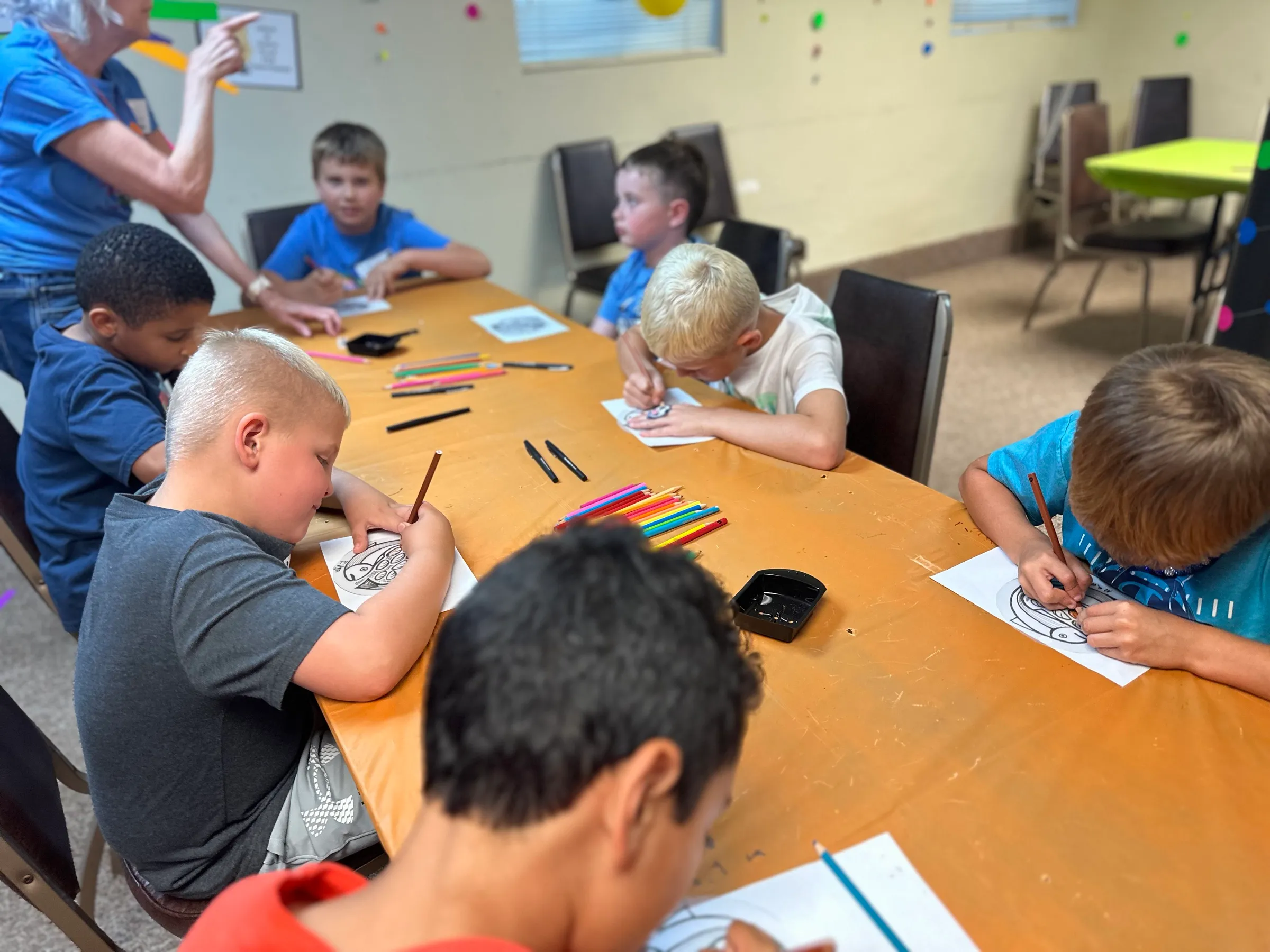 Children colouring at a classroom table